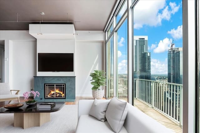 360 Nueces St Unit 4305, Austin, TX 78701 - living area featuring a warm lit fireplace, healthy amount of natural light, and a wall of windows