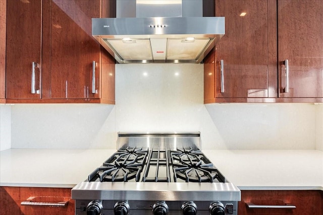 kitchen with stove and wall chimney exhaust hood