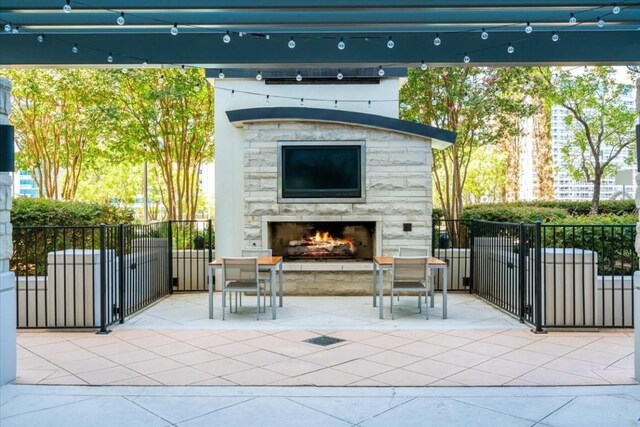 360 Nueces St Unit 4305, Austin, TX 78701 - view of patio / terrace featuring an outdoor stone fireplace and a gate
