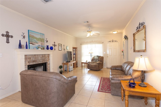 tiled living room with ceiling fan, a brick fireplace, and crown molding