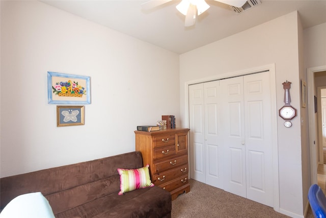 sitting room featuring ceiling fan and carpet flooring