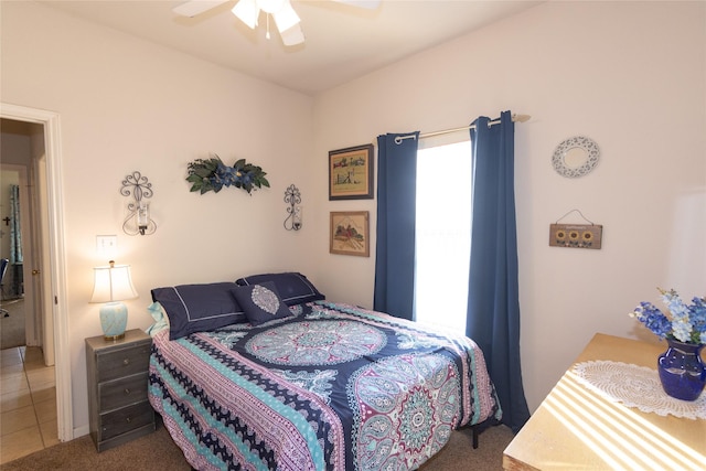 tiled bedroom featuring ceiling fan