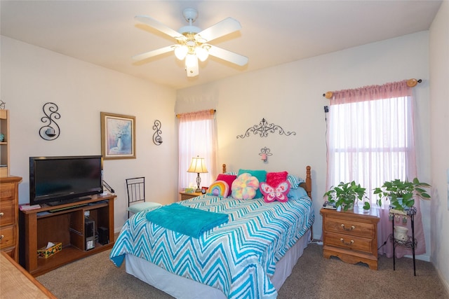 bedroom featuring ceiling fan, carpet, and multiple windows