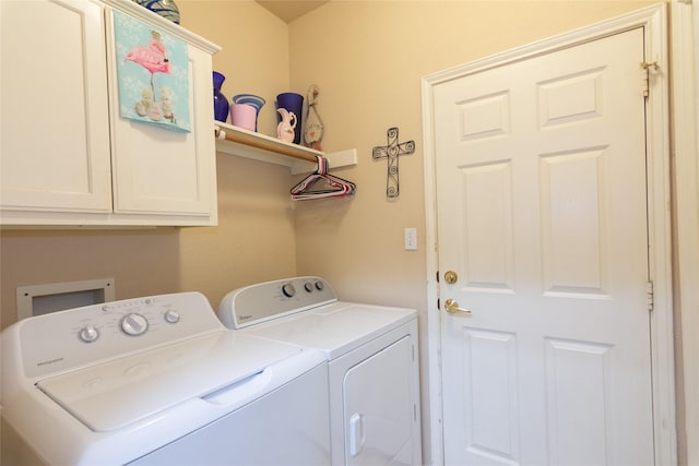 laundry area featuring cabinets and separate washer and dryer