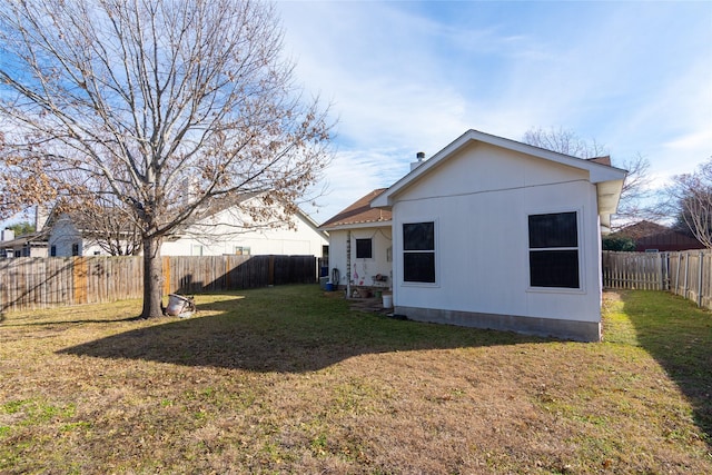 back of house with a yard