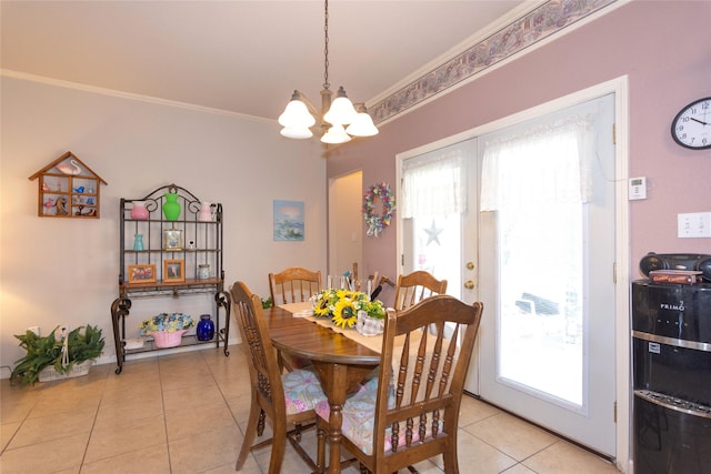 dining area featuring a wealth of natural light, light tile patterned floors, ornamental molding, and a notable chandelier