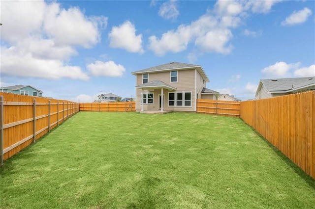 rear view of house with a yard