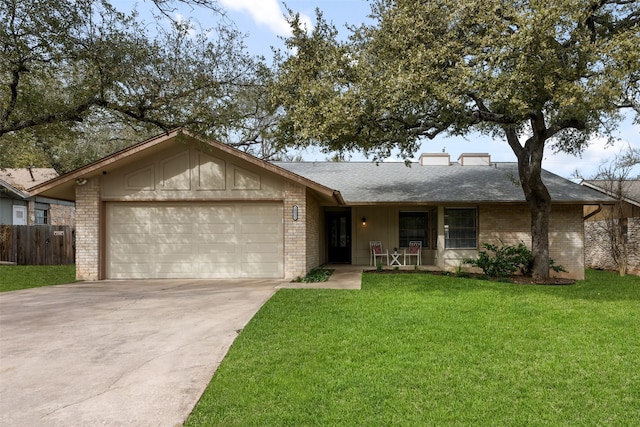 single story home featuring a front yard and a garage