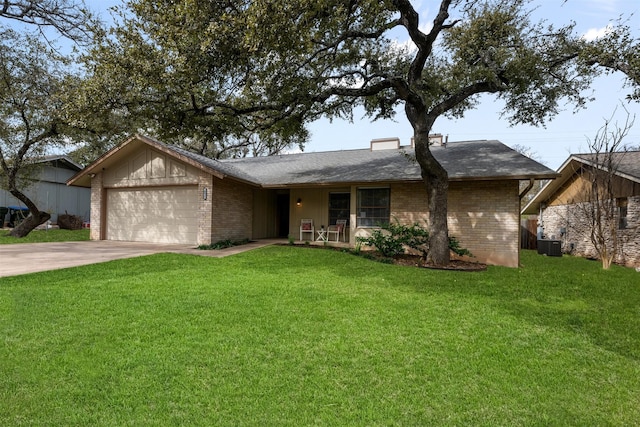 ranch-style home featuring a garage, cooling unit, and a front lawn