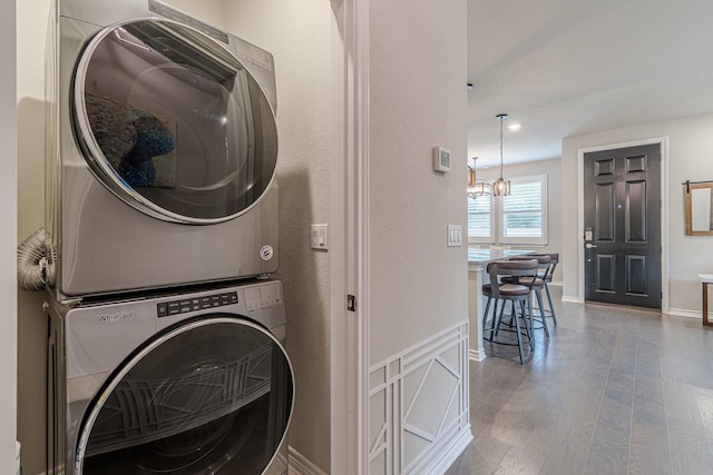 washroom featuring stacked washer / dryer and hardwood / wood-style flooring