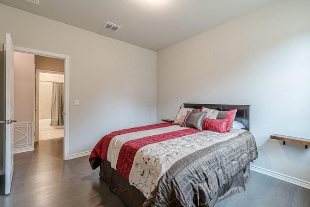 bedroom with dark hardwood / wood-style floors