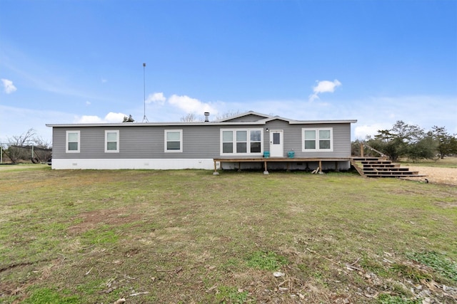 rear view of property with a lawn