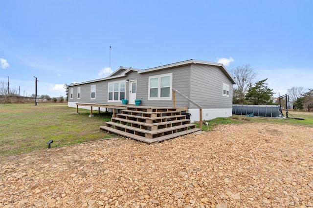 rear view of house featuring a yard