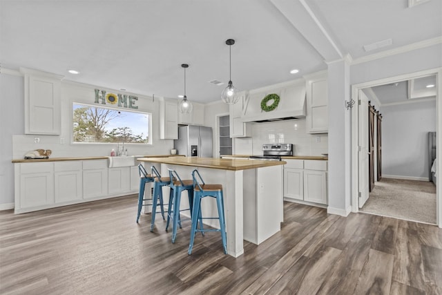 kitchen featuring wood counters, white cabinetry, and a kitchen island