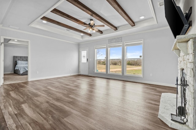 unfurnished living room featuring ceiling fan, crown molding, a raised ceiling, and hardwood / wood-style flooring