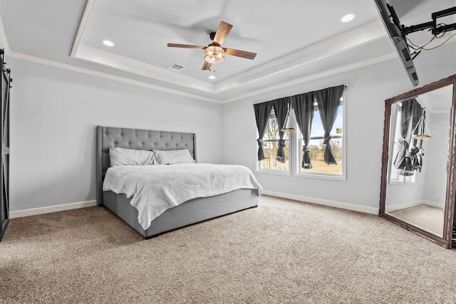 carpeted bedroom featuring ceiling fan, a tray ceiling, and crown molding