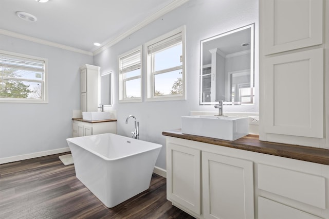 bathroom with hardwood / wood-style flooring, a washtub, and a wealth of natural light