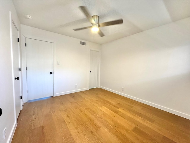 unfurnished bedroom with ceiling fan and light hardwood / wood-style floors