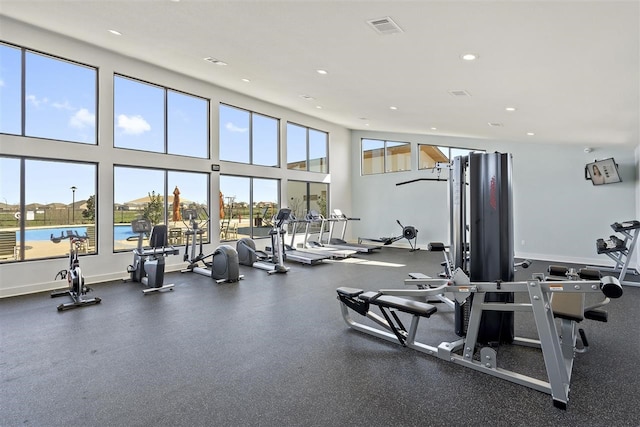 gym with a water view and a healthy amount of sunlight