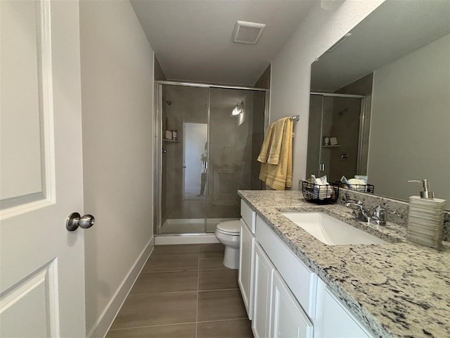 bathroom with toilet, tile patterned flooring, walk in shower, and vanity