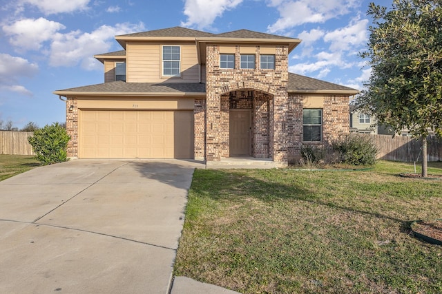 view of front of property featuring a garage and a front lawn