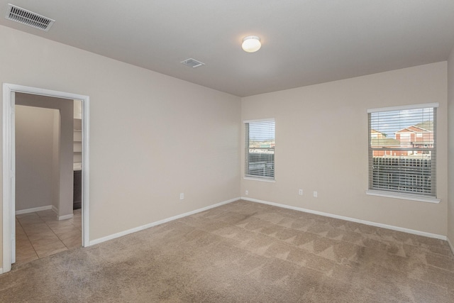 spare room with light colored carpet