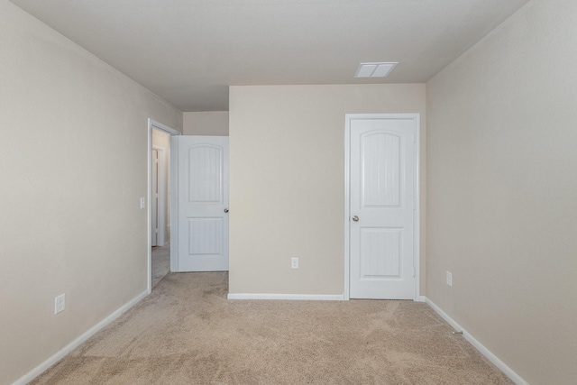 unfurnished bedroom featuring light colored carpet