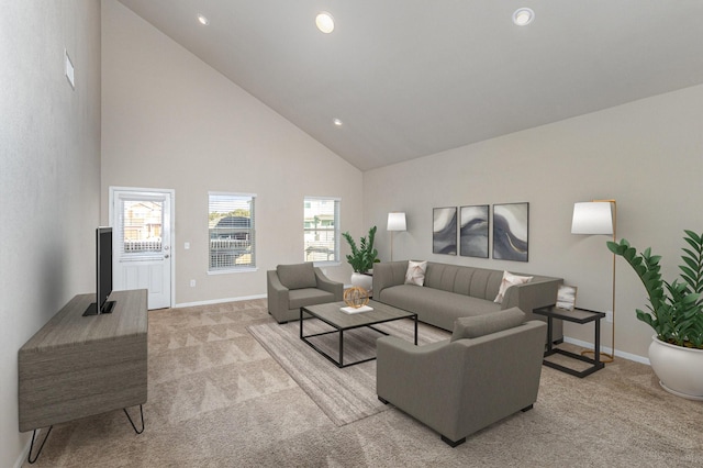 carpeted living room with high vaulted ceiling