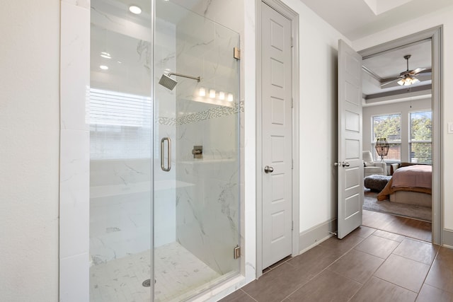 bathroom featuring ceiling fan, an enclosed shower, and tile patterned flooring