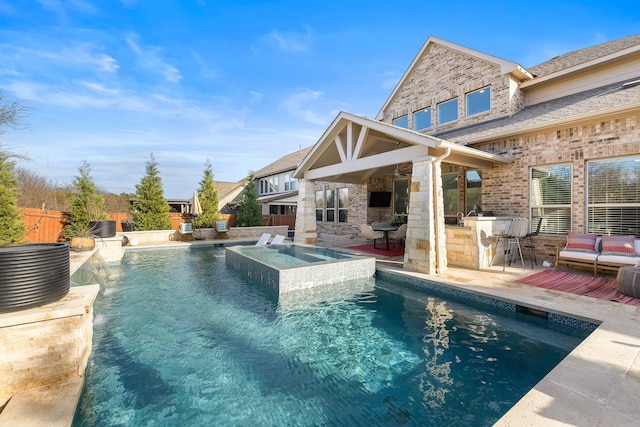 view of pool with an in ground hot tub, a bar, and central air condition unit