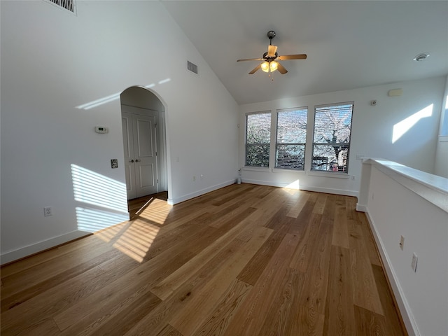 unfurnished room featuring ceiling fan, hardwood / wood-style floors, and vaulted ceiling