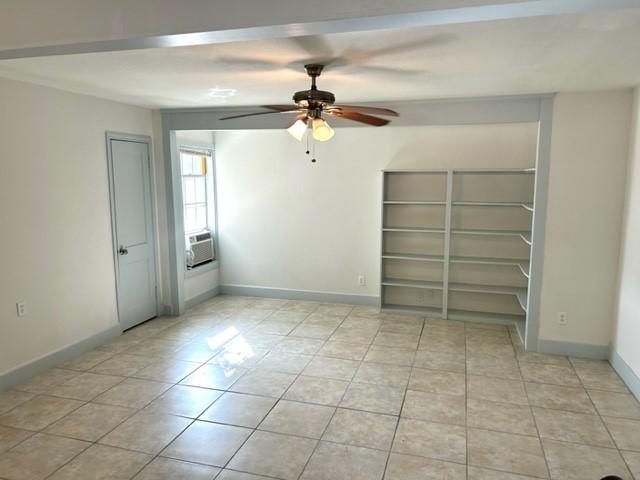 unfurnished bedroom featuring ceiling fan and light tile patterned floors