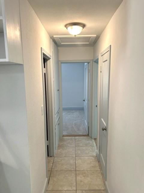 hallway featuring light tile patterned flooring