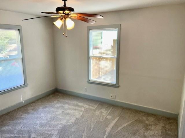 carpeted empty room featuring ceiling fan