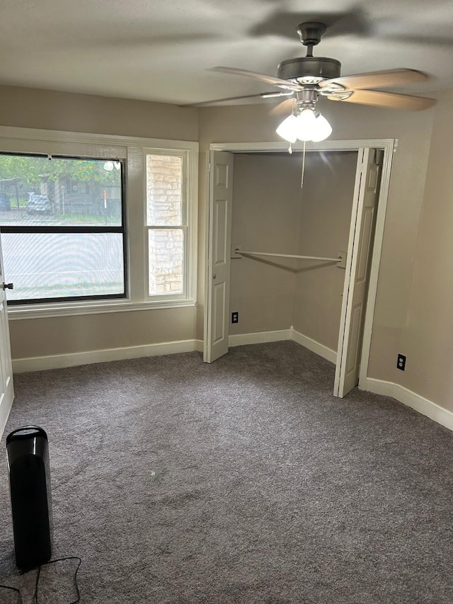 unfurnished bedroom with ceiling fan, a closet, and carpet floors