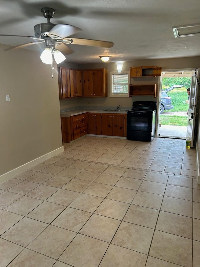 kitchen with ceiling fan, light tile patterned floors, electric range, and sink