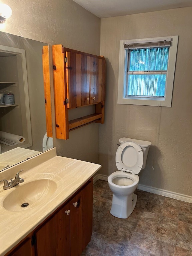 bathroom featuring toilet and vanity