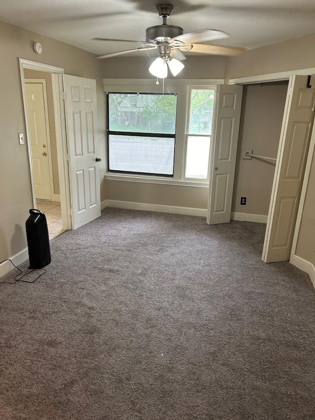 unfurnished bedroom featuring ceiling fan, a closet, and light colored carpet