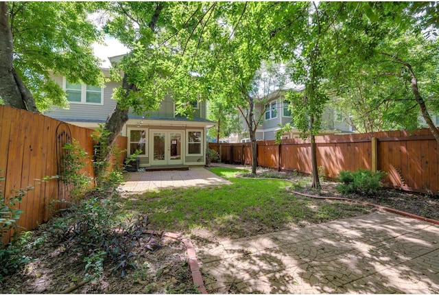 view of yard with french doors and a patio