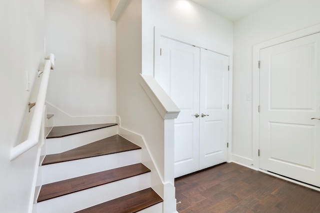 staircase with hardwood / wood-style flooring