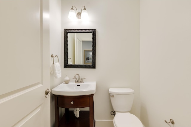 bathroom featuring toilet and vanity