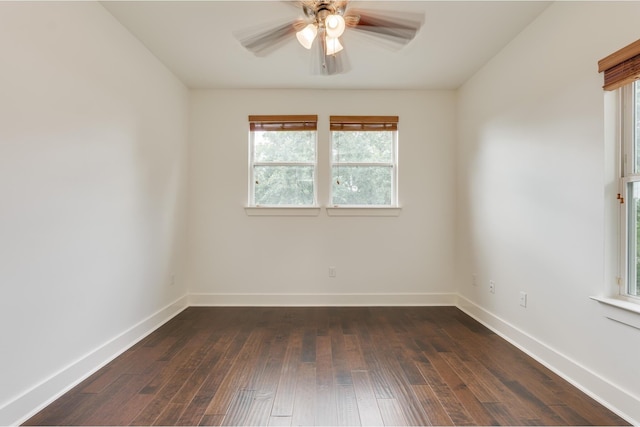 empty room featuring ceiling fan and dark hardwood / wood-style flooring