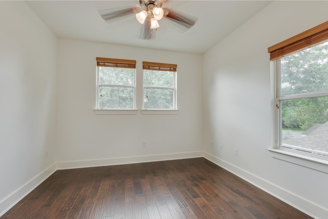 spare room with dark wood-type flooring and ceiling fan