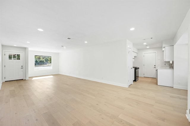 unfurnished living room with light wood-type flooring