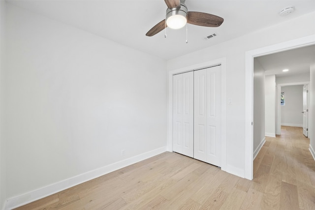 unfurnished bedroom featuring ceiling fan, a closet, and light hardwood / wood-style floors