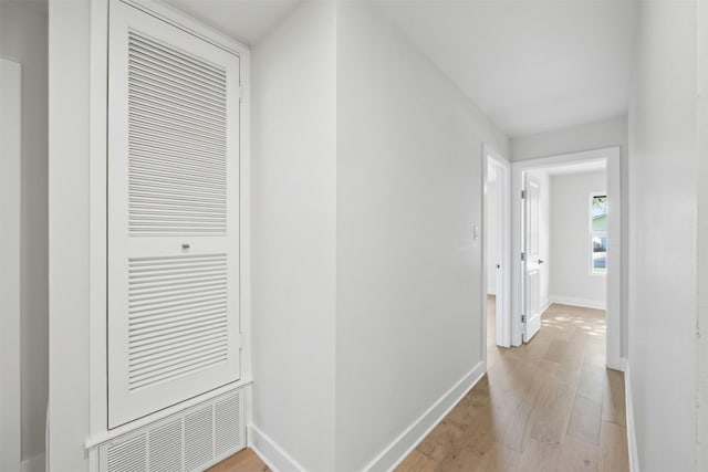 corridor with light hardwood / wood-style floors