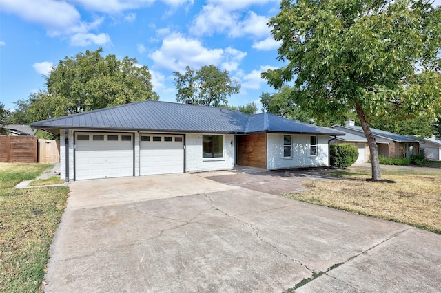 ranch-style home with a garage and a front lawn