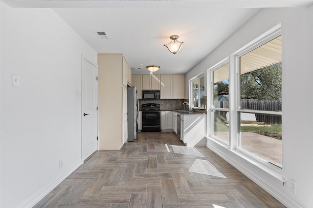 kitchen with decorative backsplash, sink, dark parquet floors, and stainless steel appliances