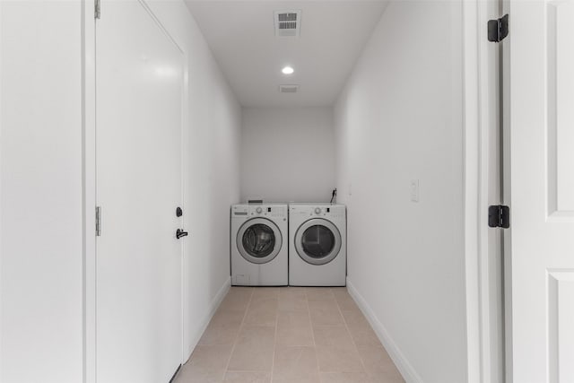 washroom featuring washer and dryer and light tile patterned flooring