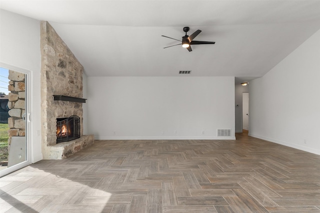 unfurnished living room featuring ceiling fan, a stone fireplace, and parquet flooring